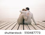 Couple hugging on a pier