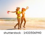 Couple girl running on the beach relaxing summer vacation.Young fashion woman relax on the beach. Happy island lifestyle.crystal. Vacation at Paradise. Ocean beach relax.