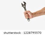 Small photo of Partial view of man holding monkey wrench isolated on white