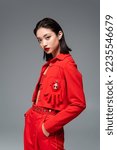 Asian woman in red jacket...