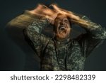 Small photo of long exposure of soldier in uniform screaming while suffering from dissociation disorder isolated on dark grey