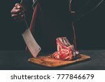 Butcher With Cleaver And Raw...