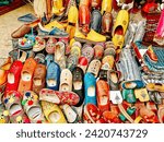 Small photo of Tangier, Morocco - December 29, 2023: A selection of traditional shoes displayed at a souk vendor in Tangier, Morocco