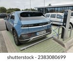 Small photo of SANTA URSULA, SPAIN - JULY 19, 2023: Hyundai IONIQ 5 electric charging in a large outdoor parking lot. This is a CUV CrossOver Utility Vehicle with an ultra-fast charging system