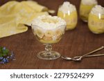 Glasses with delicious banana pudding on table.