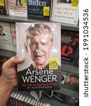 Small photo of Shah Alam, Malaysia - 29 May 2021 : Hand hold a book title ARSENE WENGER for sell in the book stores with selective focus.
