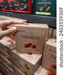 Small photo of Sepang, Malaysia - 2 December 2023 : Hand pickup a new boxed of BERYL'S Tiramisu Milk Chocolate for sell in BERYL'S Shop at Sepang, Malaysia with selective focus.