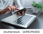 Blurred hand of woman is touch, slide, press on screen of phone for check e-mail, news, prepare of  meeting presentation, get promotion information for shopping online or operation of internet banking