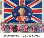 Small photo of London, UK - 06.05.2022: platinum jubilee display of union jack flag with queen Elizabeth and crown on it to celebrate 70 years on throne and bunting