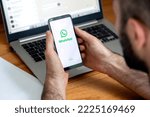 Small photo of WhatsApp app logo on the phone screen in a man's hands. Smartphone with white background display and green logotype. SYDNEY, AUSTRALIA - NOVEMBER 10, 2022.