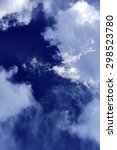 Small photo of Deepening blue of partly cloudy sky at sunset in summer (hexadecimal sample of clearest area: 080F54), for themes of change, formation, transition