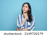 Small photo of young asian woman look up considering think and doubt why