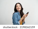 Small photo of Happy Asian woman holding a smartphone and winning the prize.