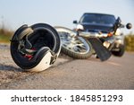 Small photo of Photo of car, helmet and motorcycle on road, the concept of road accidents.