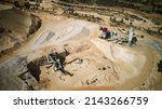 Small photo of Aerial view of crushed stone quarry machine. Producing of construction materials at open pit limestone mine. Stone crushing plant. Cone type rock crusher