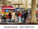 Small photo of Bucharest, Romania - April 01, 2021: A panning shot with an Emergency Service for Resuscitation and Extrication, short named SMURD, ambulance speeding through a crosswalk in heavy traffic in Bucharest