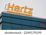 Small photo of Bucharest, Romania - January 13, 2023: The logo of the American car rental company Hertz can be seen on a building
