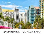 Miami South Beach Ocean Drive road street with famous retro art deco hotel colorful buildings cityscape with palm trees and blue sky on sunny day