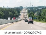 Small photo of Gaston, USA - July 6, 2021: Interstate highway i26 26 in South Carolina with rest area sign and many cars vehicles trucks in traffic and billboard for accidents law firm near Columbia, SC