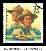 Small photo of UNITED STATES OF AMERICA - CIRCA 1998: A stamp printed in USA shows Boy Scouts started in 1910, Girl Scouts formed in 1912, series Celebrate the Century, 1910s, circa 1998