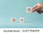Small photo of Concept of customer satisfaction review. Wooden blocks with facial expression and the "Best score" was chosen. To evaluate business performance you need a survey from customer experience.