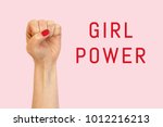a woman hand on a pink... | Shutterstock . vector #1012216213
