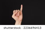 Small photo of Little finger or pinkie gesture hand sign on black background.