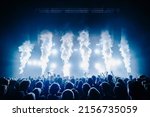 Small photo of Co2 flame and silhouette of crowd at a music festival in front of bright stage lights