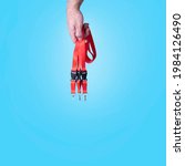 Small photo of Hand holding red Lanyards with Metal Lobster Clip and Safety Breakaway Clasp. Over blue background.Space for text.