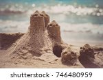 Small photo of Sand castle standing on the beach. Travel vacations concept.