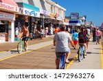 Small photo of Wildwood, NJ, USA August 23 Bikers ride on a crowded boardwalk, swerving between pedestrians, in Wildwood, New Jersey