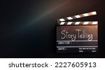 Small photo of 2023 story.hand writing on film slate or movie clapboard for the filmmaker.storytelling concept of darkness background.