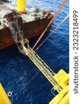 Small photo of Gangway from supply boat or barge to the oil and gas platform. The activity supported man power to work on the platform. Oil and gas construction activities and support service job.