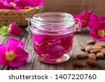 Small photo of Rugosa rose petals macerating in almond oil, to prepare homemade skin tonic