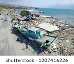 Small photo of The impact of the tsunami that occurred along the Palu bay and the Wani ship port that occurred on 28 September 2018