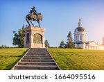 Monument to Dmitry Donskoy near the wall of the Kolomna Kremlin and the Church of Archangel Michael on a sunny summer evening