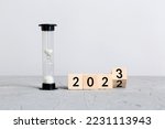 New Year 2023 sand timer. Resolution, time, plan, goal, motivation, reboot, countdown and New Year holiday concepts. Hourglass with number 2023.