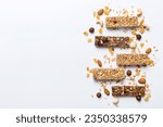 Various granola bars on table background. Cereal granola bars. Superfood breakfast bars with oats, nuts and berries, close up. Superfood concept.