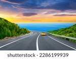 holiday road landscape in summer. car driving on the road of europe. Highway landscape at colorful sunset. Beautiful nature scenery on ocean beach. Road view on the sea. coastal freeway in vacation.