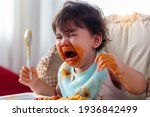 Small photo of Wayward little toddler child or infant baby crying that don't want eating food on baby chair Cute infant children get hungry and want new food Children get dirty Kid get tantrum Baby is stubborn baby