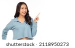 Small photo of Beautiful young Asian woman pointing up to copy space and looking at camera with smile face and happiness Pretty girl act like a satisfied product, use for advertising with white background copy space