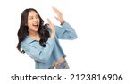 Small photo of Surprised happy beauty asian woman looking copy space in excitement. Expressive facial expressions. Presenting some product. Beautiful girl act like a pushing something Isolated on white background