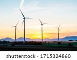 4 Wind Turbines Stand In A...
