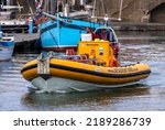 Small photo of LOWESTOFT, SUFFOLK, UK â€“ JULY 30, 2022: Jet Adventures RIB 1091B manoeuvres in Lowestoft harbour, about to pick up passengers to watch the International Smack Race Festival from the offshore waters.