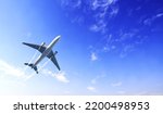 Small photo of Horizontal nature background with aircraft and Jet trailing smoke in the sky. Airplane and condensation trail. Foggy trail jet and plane in blue sky with white clouds. Traveling the world concept