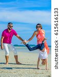 Small photo of Happy family of three at the tropical beach, laughing and enjoying time together. turn handsprings