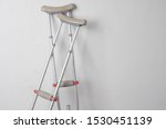 Small photo of Crutches. Fractured legs. Crutches as a sign of disability. Symbol of disability. Rehabilitation in case of injury. Concept - workplace injury. Life with disabilities. Personal injury. Injuries.
