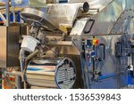 Small photo of Food industry. Seafood processing. A fragment of the conveyor in the processing of shrimp. A machine for processing shrimp. Quick-freeze shrimp. Seafood semi-finished products.