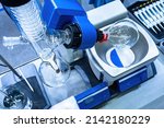 Small photo of Fragment of a rotary evaporator close-up. Rotary evaporator in a medical laboratory. Concept is use of rotary evaporator for research. Laboratory equipment with glass flasks. Machine in medical lab