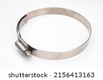 Small photo of Steel clamp close up. Steel hose clip.Clamp with cross screw. Metal element for repair and construction. Steel clamp on white background. Concept - sale of construction spare parts.